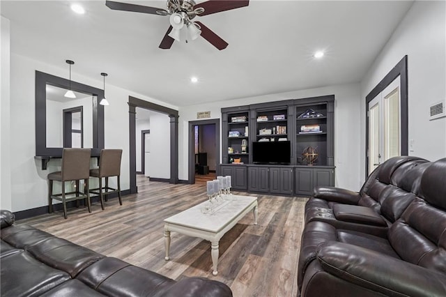 2945 Ashbyrn Ct, Buford, GA 30519 - living room featuring wood finished floors, a ceiling fan, recessed lighting, baseboards, and decorative columns