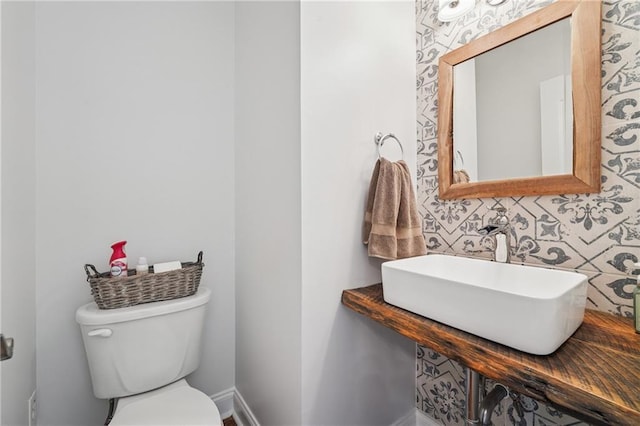2945 Ashbyrn Ct, Buford, GA 30519 - half bathroom with a sink, toilet, and baseboards