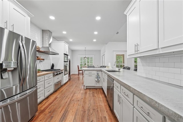 2945 Ashbyrn Ct, Buford, GA 30519 - kitchen with stainless steel appliances, a sink, wall chimney exhaust hood, recessed lighting, and decorative backsplash