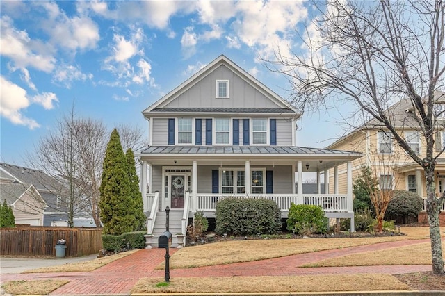 view of front of house featuring covered porch and a front yard