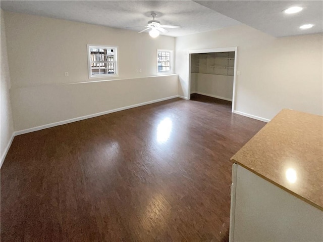 unfurnished living room with dark wood finished floors, recessed lighting, ceiling fan, and baseboards