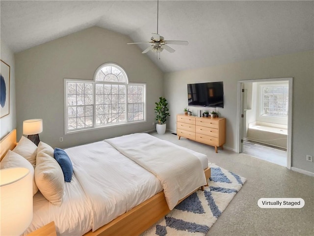 carpeted bedroom featuring connected bathroom, baseboards, lofted ceiling, and ceiling fan