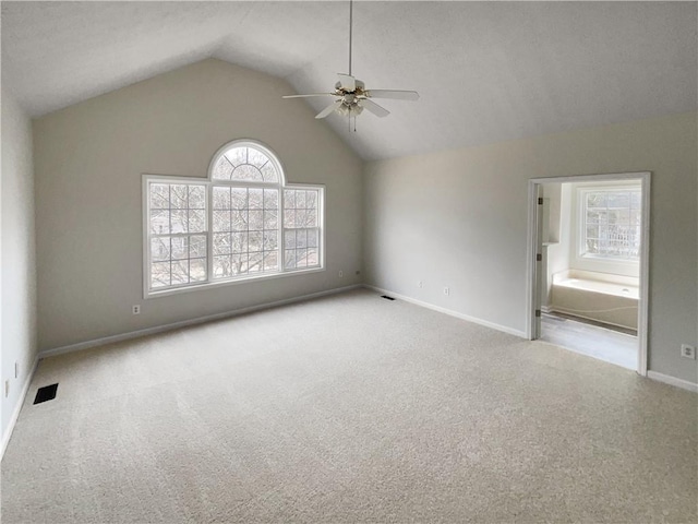 unfurnished room with visible vents, a ceiling fan, carpet flooring, baseboards, and vaulted ceiling