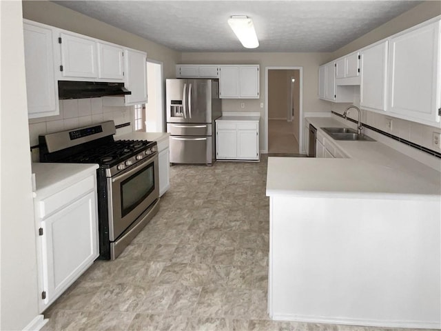 kitchen featuring a sink, light countertops, under cabinet range hood, appliances with stainless steel finishes, and white cabinetry