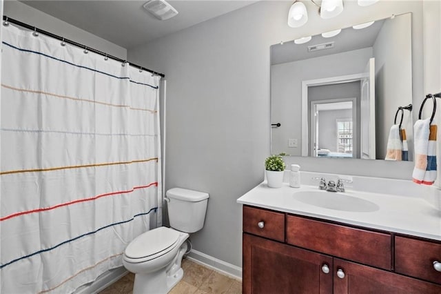 bathroom with vanity, toilet, a shower with shower curtain, and tile patterned floors