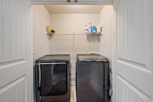 clothes washing area featuring washer and clothes dryer