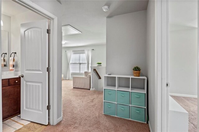 corridor featuring light colored carpet