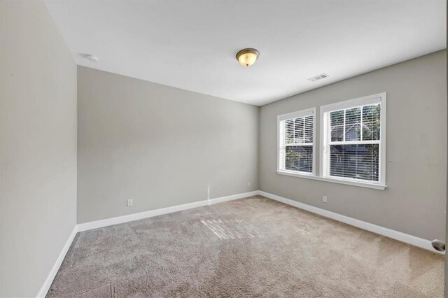 spare room with light colored carpet