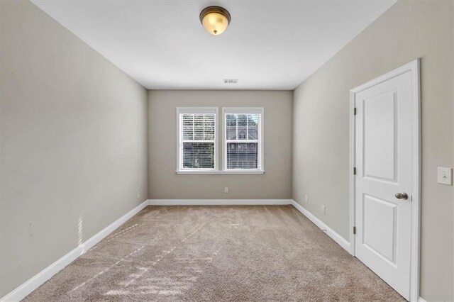 spare room with light colored carpet