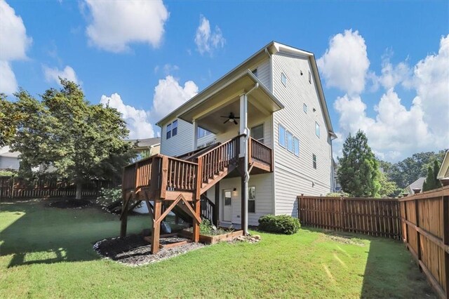 back of house with a yard and ceiling fan