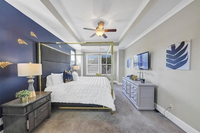 carpeted bedroom featuring ornamental molding, a raised ceiling, and ceiling fan