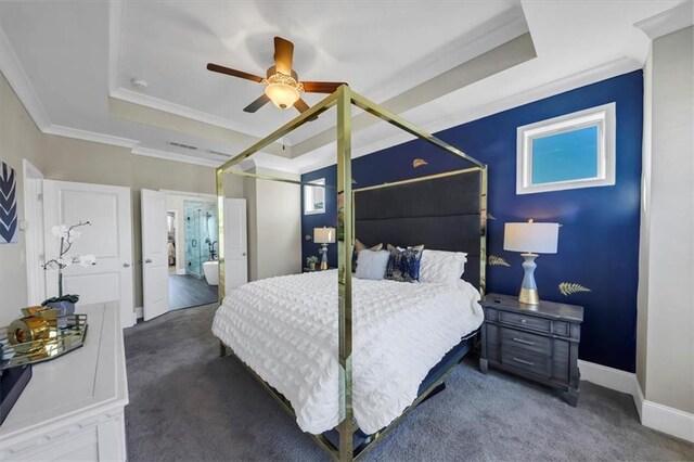 carpeted bedroom with connected bathroom, crown molding, a raised ceiling, and ceiling fan