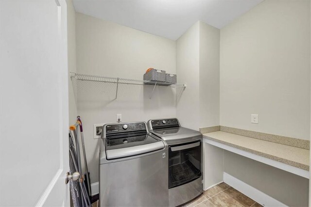 laundry area featuring separate washer and dryer and light tile patterned floors