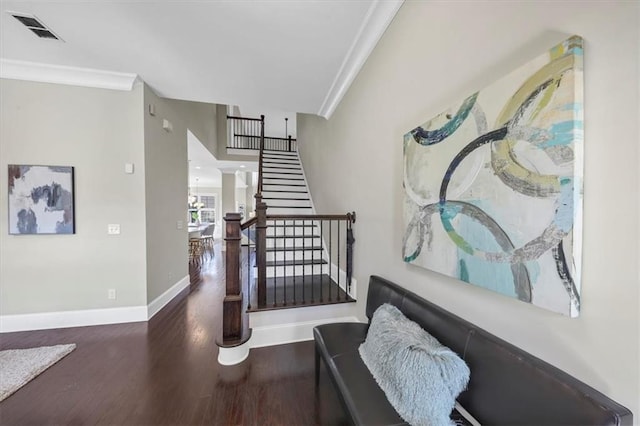 stairs featuring ornamental molding and hardwood / wood-style floors