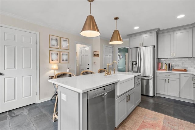 kitchen featuring gray cabinets, decorative light fixtures, an island with sink, a breakfast bar area, and stainless steel appliances