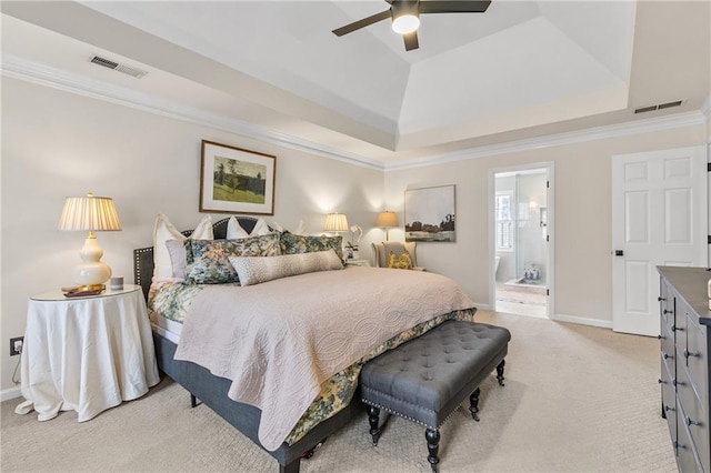 carpeted bedroom featuring crown molding, ensuite bath, a raised ceiling, and ceiling fan