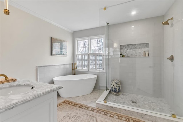 bathroom with ornamental molding, vanity, shower with separate bathtub, and tile walls