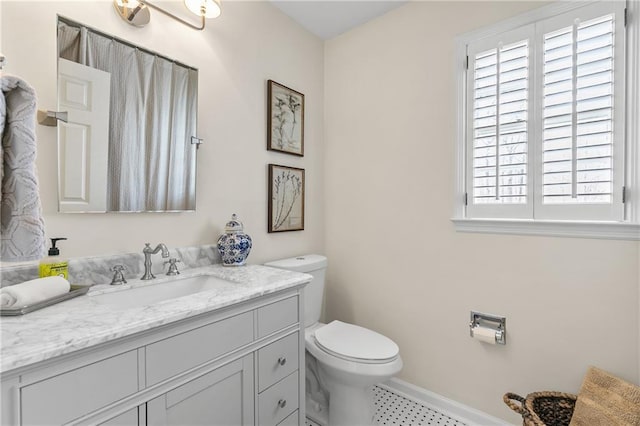 bathroom featuring vanity and toilet