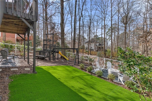 view of yard with a playground and an outdoor fire pit