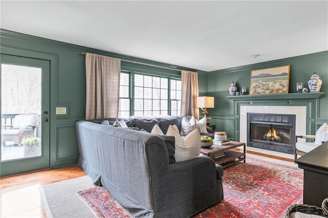 living room with ornamental molding and hardwood / wood-style floors