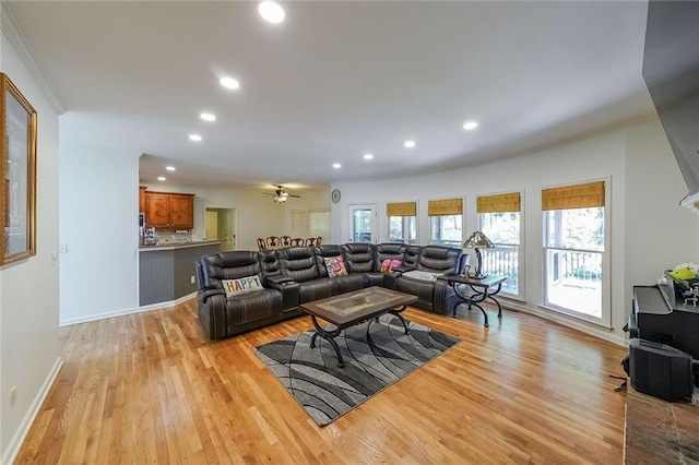 living room featuring light hardwood / wood-style flooring and ceiling fan