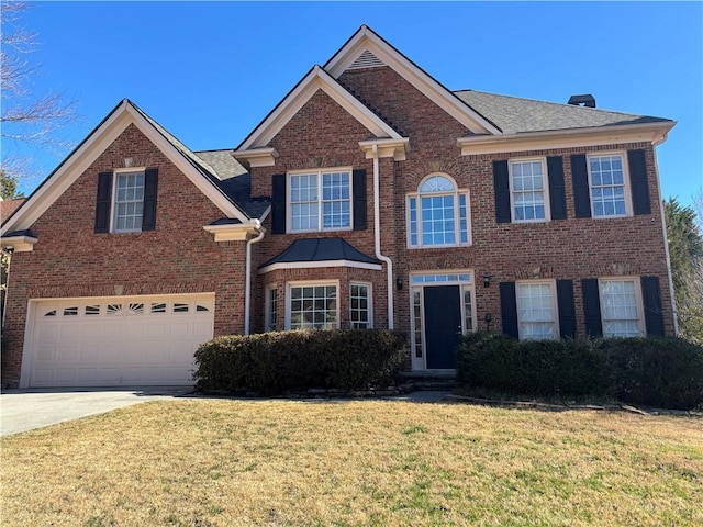 view of front of house with brick siding, a garage, concrete driveway, and a front yard