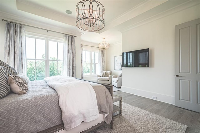 bedroom with ornamental molding, dark wood-type flooring, and a notable chandelier