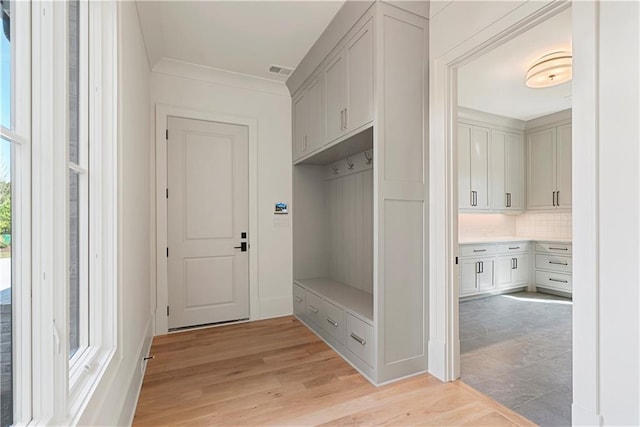 mudroom featuring light hardwood / wood-style floors and ornamental molding