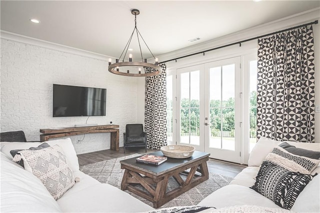 living room featuring hardwood / wood-style floors, ornamental molding, and french doors