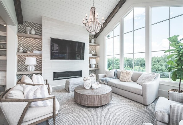 living room featuring a chandelier, vaulted ceiling with beams, and a fireplace