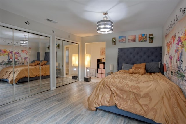 4938 Terrace Green Trce, Stone Mountain, GA 30088 - bedroom featuring two closets, wood finished floors, and a chandelier