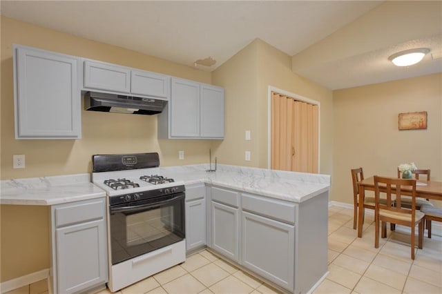 4938 Terrace Green Trce, Stone Mountain, GA 30088 - kitchen with under cabinet range hood, gas stove, a peninsula, light tile patterned flooring, and light stone countertops