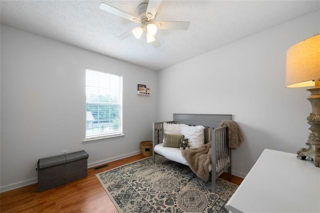 427 Pleasant Way, Temple, GA 30179 - bedroom with wood finished floors, ceiling fan, and a textured ceiling