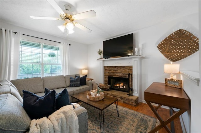 427 Pleasant Way, Temple, GA 30179 - living area with wood finished floors, a textured ceiling, a fireplace, and ceiling fan