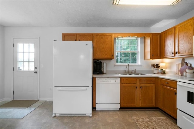 427 Pleasant Way, Temple, GA 30179 - kitchen featuring white appliances, light countertops, brown cabinetry, and a textured ceiling