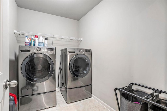 washroom with washing machine and clothes dryer