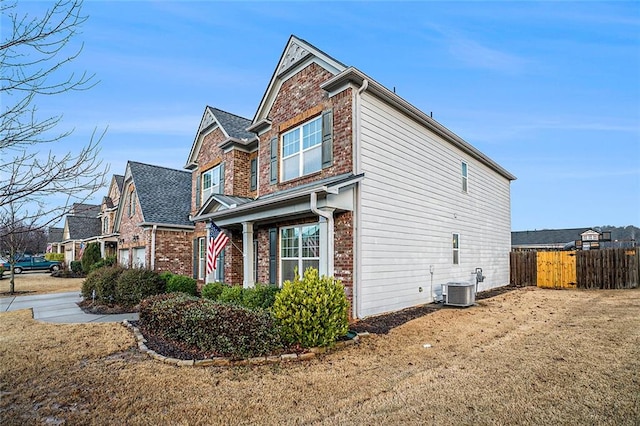 view of side of property with a garage and central AC unit