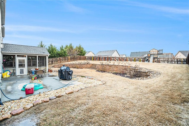 view of yard featuring a patio area and a sunroom