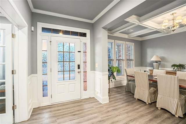 entryway featuring beam ceiling, a wealth of natural light, coffered ceiling, crown molding, and light hardwood / wood-style floors