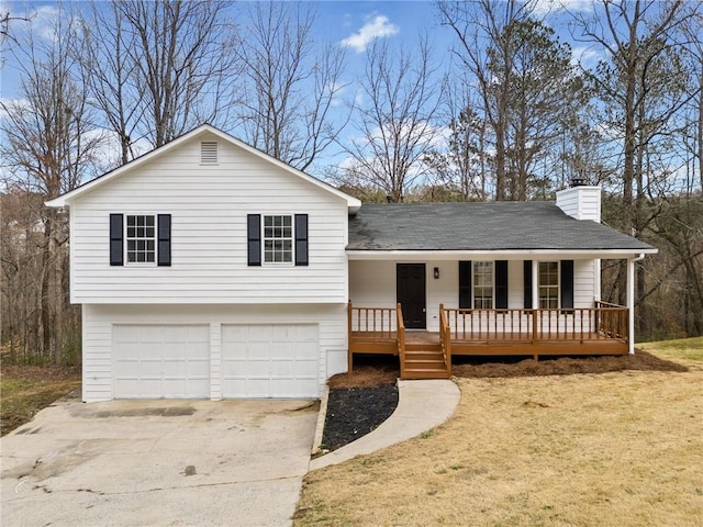 tri-level home with a garage and a porch