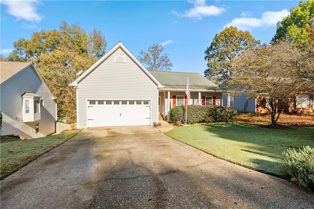 view of property featuring a garage and a front lawn