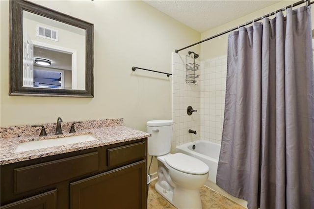 full bathroom featuring shower / tub combo, vanity, a textured ceiling, and toilet