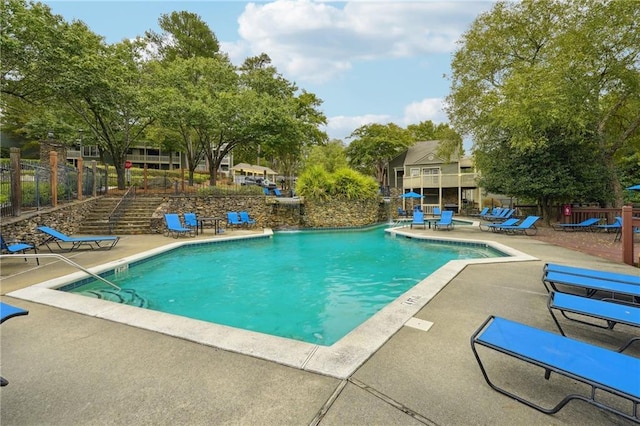 view of swimming pool with a patio