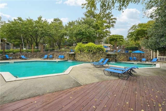 view of pool with a patio and pool water feature