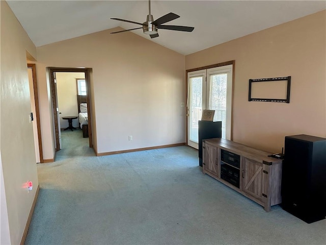 unfurnished living room with ceiling fan, light carpet, and lofted ceiling