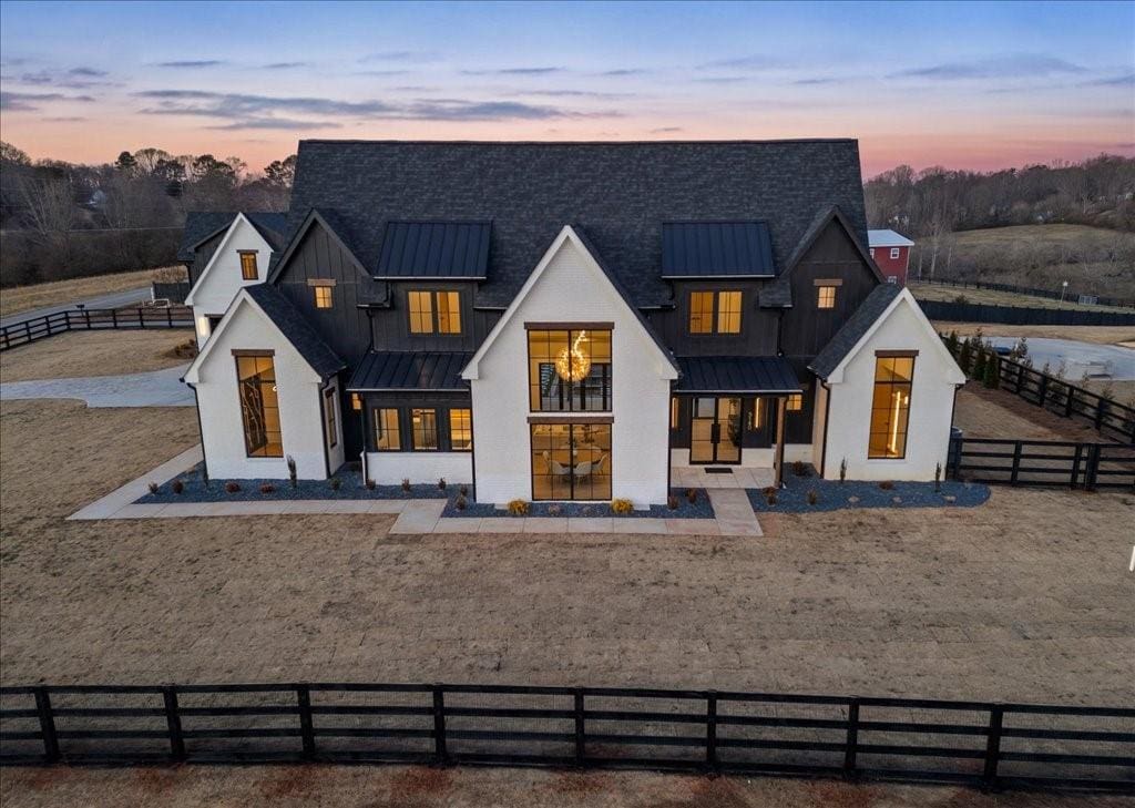 view of back house at dusk