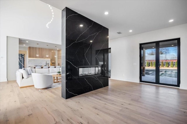 living room featuring a premium fireplace and light hardwood / wood-style floors