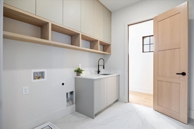 washroom featuring cabinets, electric dryer hookup, sink, and washer hookup