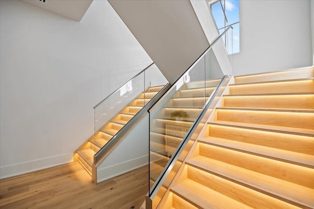 stairs featuring hardwood / wood-style flooring