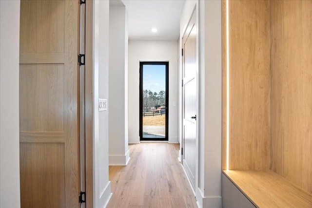 corridor with light hardwood / wood-style flooring